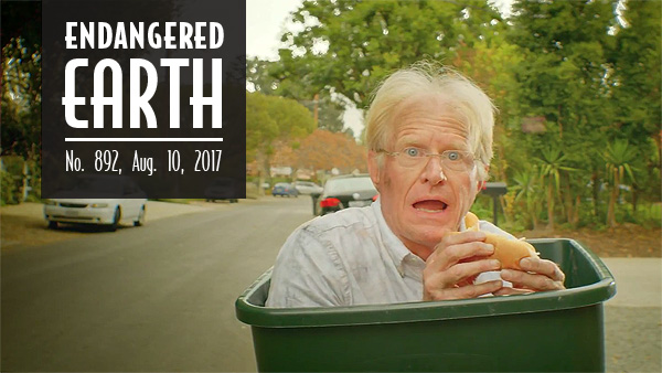 Ed Begley Jr. in a trash bin eating a trash sandwich